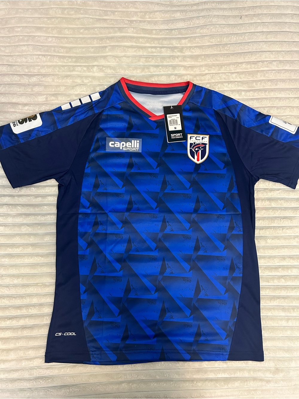Capelli of New York Men's Blue Geometric Soccer Jersey with Red Trim